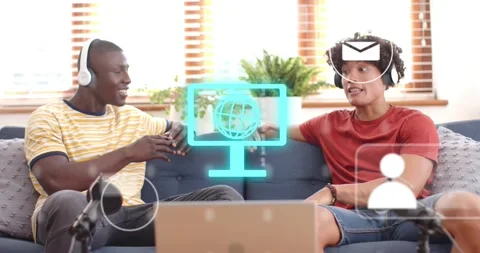 Two friends sitting sofa speaking into mics activating globe pulsing binary Stock Footage 316606820