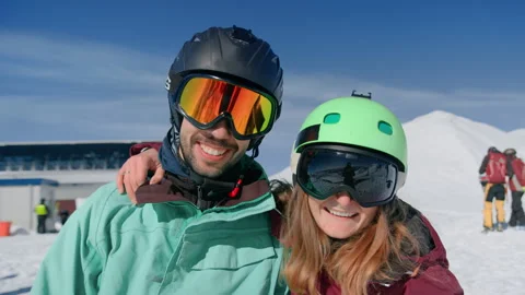 Two friends in ski goggles pose smiling for photos Stock Footage 140852334