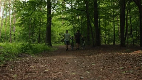 Two friends slim guy and unsportsmanlike overweight man walk roll hardtail Stock Footage 277209127