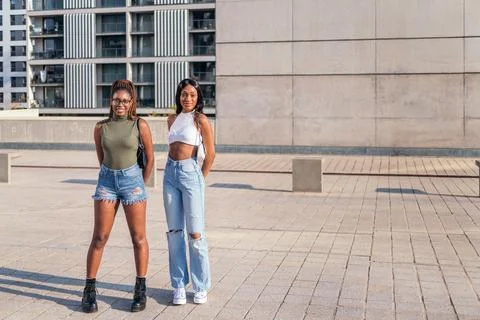 Two friends standing outdoors looking at camera Stock Photos