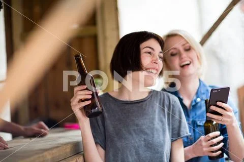 Two friends at a street food bar drinking beer Stock Photos