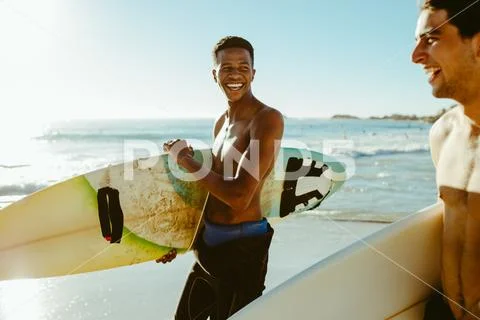 Two friends on surfing vacation at the sea Stock Photos