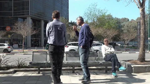 Two friends take a sit on a bench Video stock 103089837