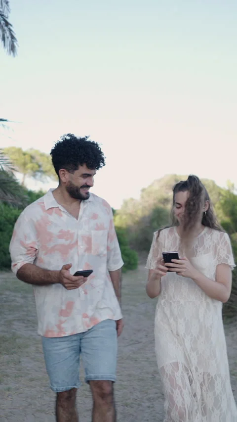 Two friends talk about something on their phone in Valencia Stock Footage 264916527