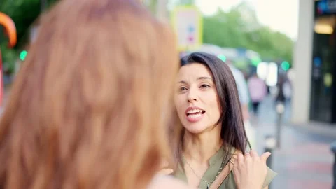 Two friends talking closely while smiling in the street Stock Footage 207456160