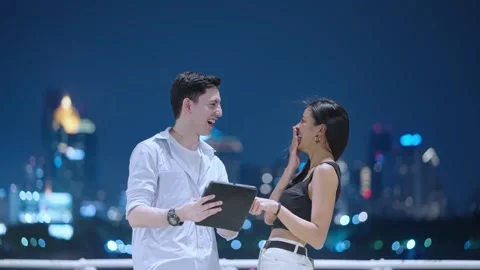 Two friends using digital tablet tapping touch screen having fun Stock Footage 276798846