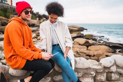 Two friends using digital tablet. Stock Photos