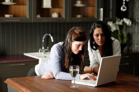 Two friends using laptop Stock Photos