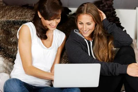 Two friends using laptop 写真素材