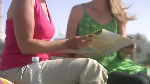 Two friends using a map Stock Footage 11287160