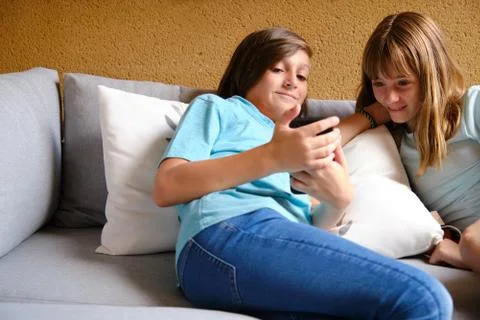 Two friends using a smartphone Stock Photos