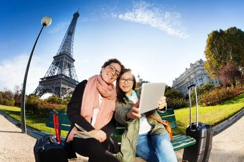 Two friends using a tablet taking selfie in Paris Stock Photos