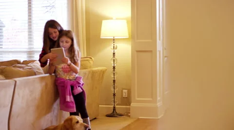Two friends using a tablet together in the living room Vídeos de archivo 63208939