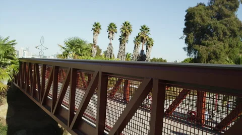 Two friends walk across a bridge during the day Stock Footage 44158635