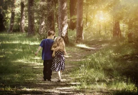 Two friends walking down path Stock Photos