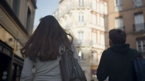 Two friends walking in a street of an authentic city in Toulouse, France Stock Footage 208900089