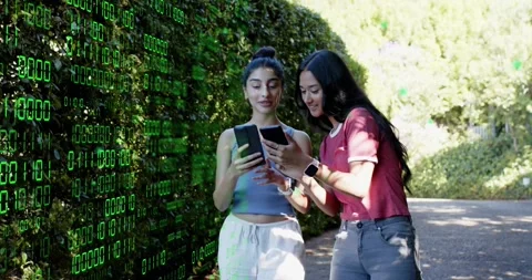 Two friends walking tapping phone projecting binary code demoing tech via selfie Stock Footage 320125593