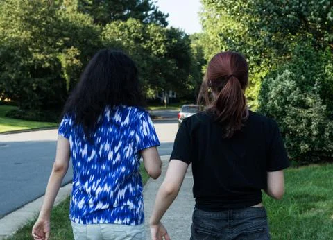 Two friends walking together Stock Photos