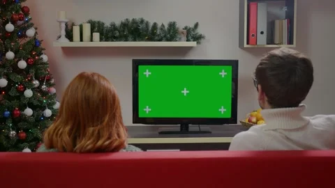 Two friends Watching Green Screen TV Mockup Sitting on Couch in Living Room Stock Footage 314781901