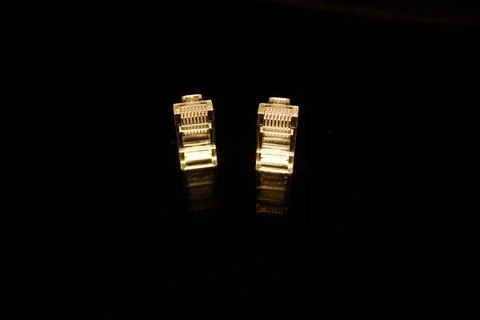 Two FTP cable data networdk connectors isolated on black with reflections Stock Photos