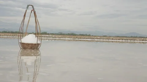 Two Full Bamboo Salt Baskets Collected by Worker Stock Footage 42452451