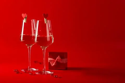 Two full glasses of wine over red background Stock Photos