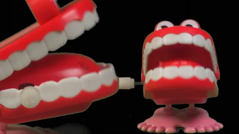 Two fun toy chattering teeth sharing a chatty joke. Stock Footage 237804924
