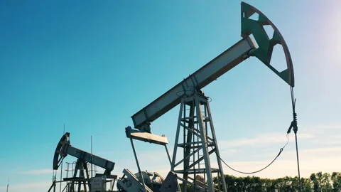 Two functioning oil pumps in an oil field Video stock 144098671