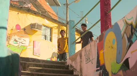 Two funky young friends shaking hands while climbing down the steps Stock Footage 61273639