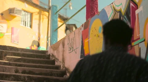 Two funky young friends watching around while climbing up the steps Stock Footage 61273642
