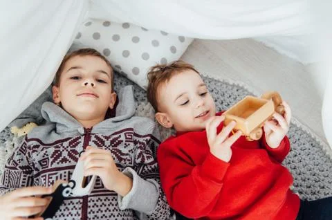 Two funny boys play together. Cute happy brothers smiling and having fun Stock Photos