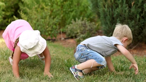 Two funny children have fun in park lying on grass Stock Footage 86120915