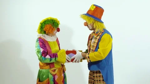 Two funny circus clown arguing for the little box Видео 70283733