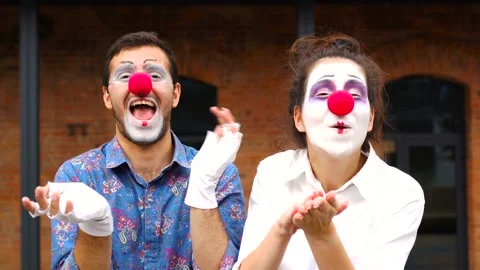 Two funny clowns clapping outdoor Stock Footage 137528000