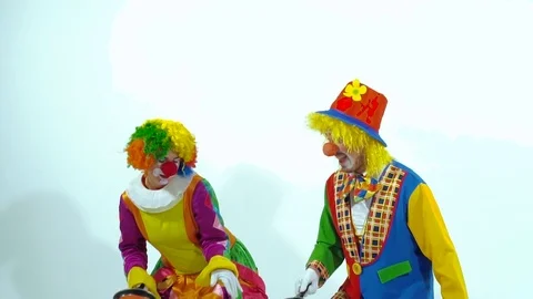 Two funny clowns trying to catch pancakes. Slow motion Видео 70514382