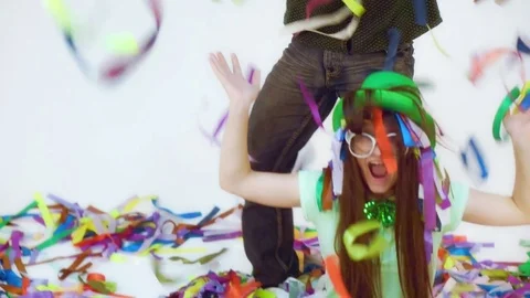 Two funny people throwing up colorful little ribbons Stock Footage 79155693