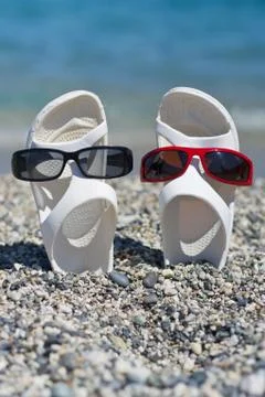 Two funny sandals on the beach Stock Photos