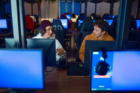 Two gamers play on computers in gaming club Stock Photos