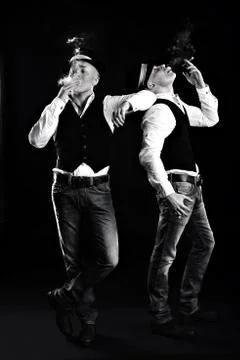 Two gangsters smoke cigars and blow smoke out of their mouths. black and whi Stock Photos