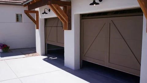 Two Garage Doors Close Lowering View from Corner of Garage Video stock 76256118