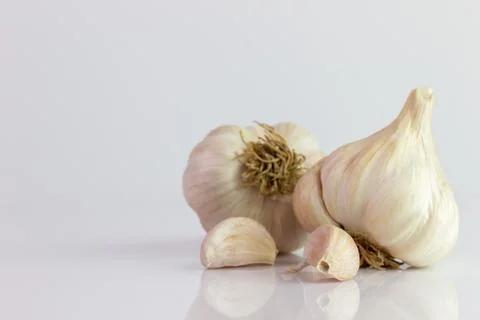 Two garlic on white background. Stock Photos