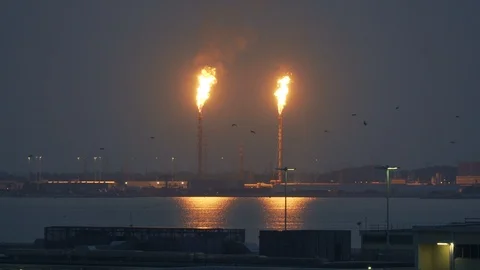 Two gas flares burning at night, wide shot Stock Footage 117857447