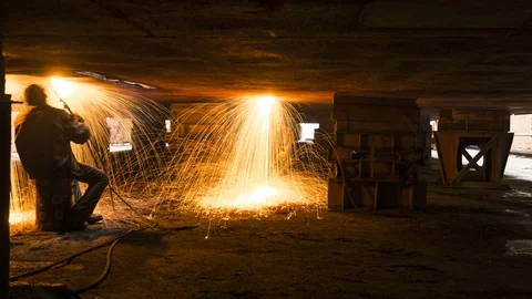 Two gas welders under the ship in dry dock Stock Footage 86785275