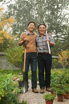 Two generation working in garden Stock Photos