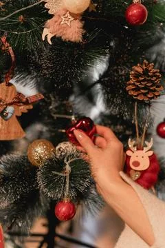 Two generations connect in silence as their hands meet over glittering gold.. Stock Photos
