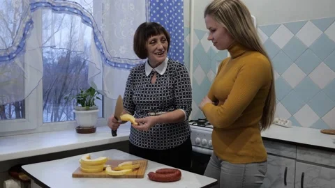 Two generations in kitchen. Mother teaches her daughter to cook Stock Footage 169027428