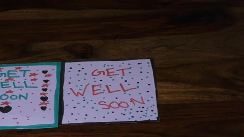 Two get well soon cards on the table with two different styles. Video stock 127017290