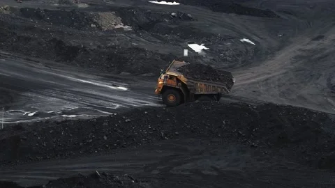 Two giant dump trucks are transporting coal in a quarry Stock Footage 145284839
