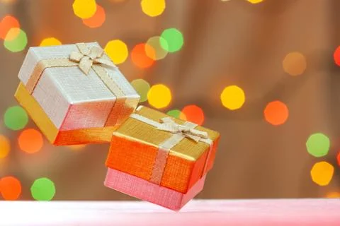 Two gift box with bow on blurred bokeh background. Stock Photos