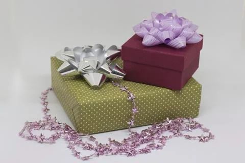 Two gift boxes and beads on a light background Stock Photos